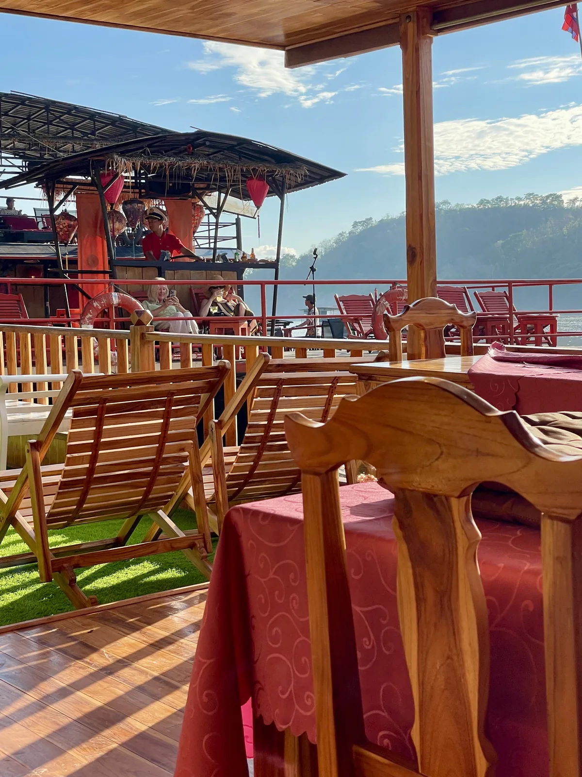 Interior of a wooden boat on the Mekong River at sunset