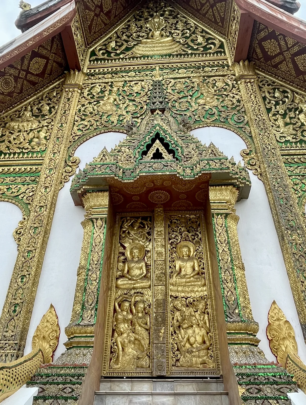 Ornate gold and green temple facade in Luang Prabang Laos