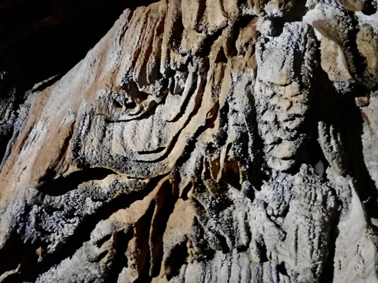 Dark rock formations deep inside a cave near Vang Vieng