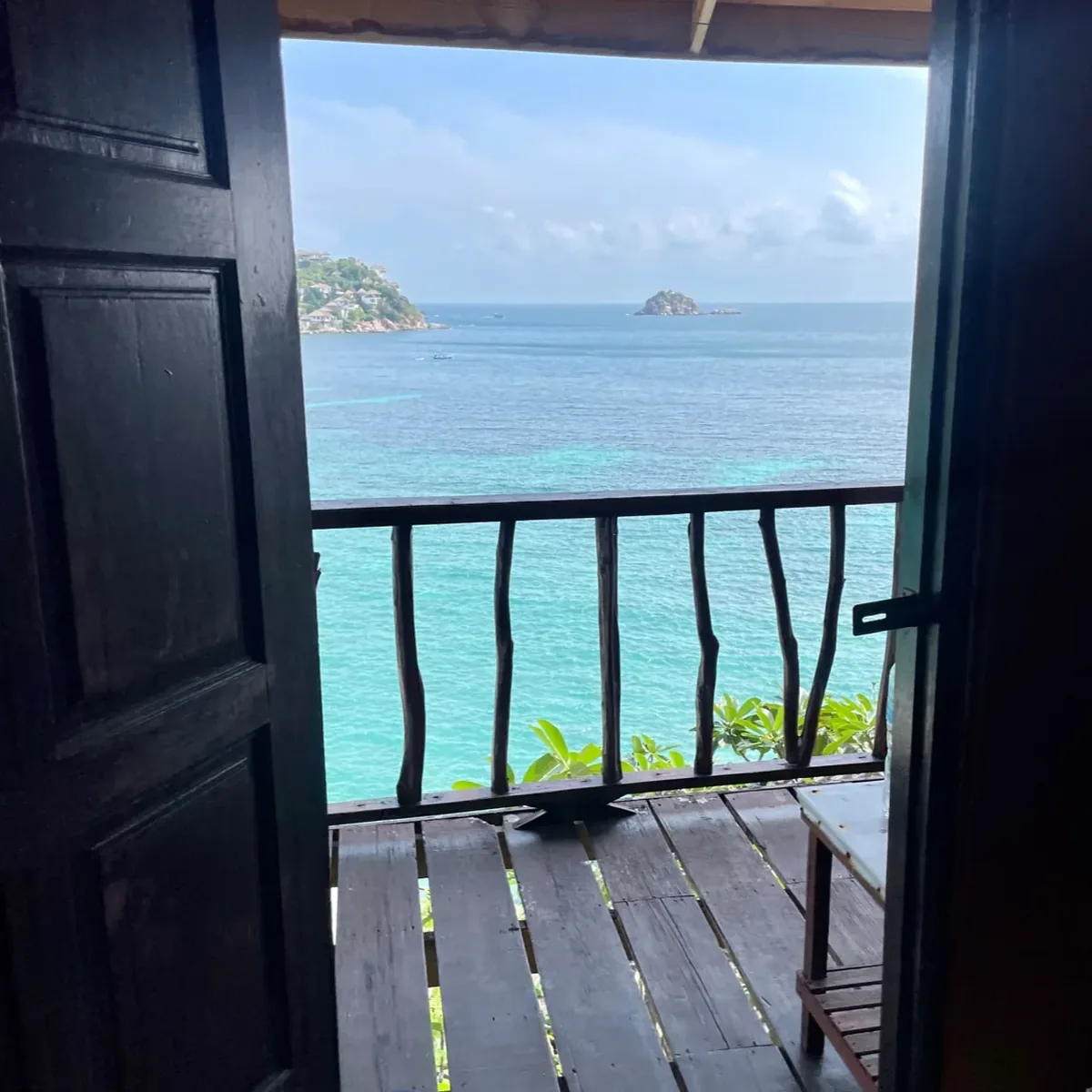 The view from a hut porch on Koh Tao, flip-flops on the deck and the bay straight ahead