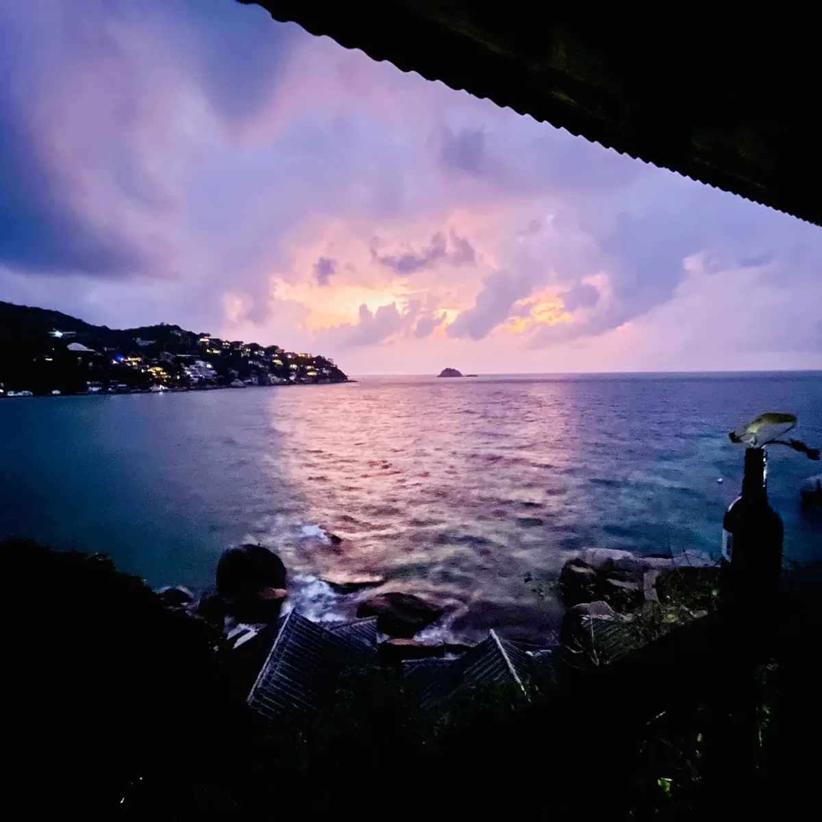 A purple sunrise over Shark Bay seen from a hillside hut on Koh Tao