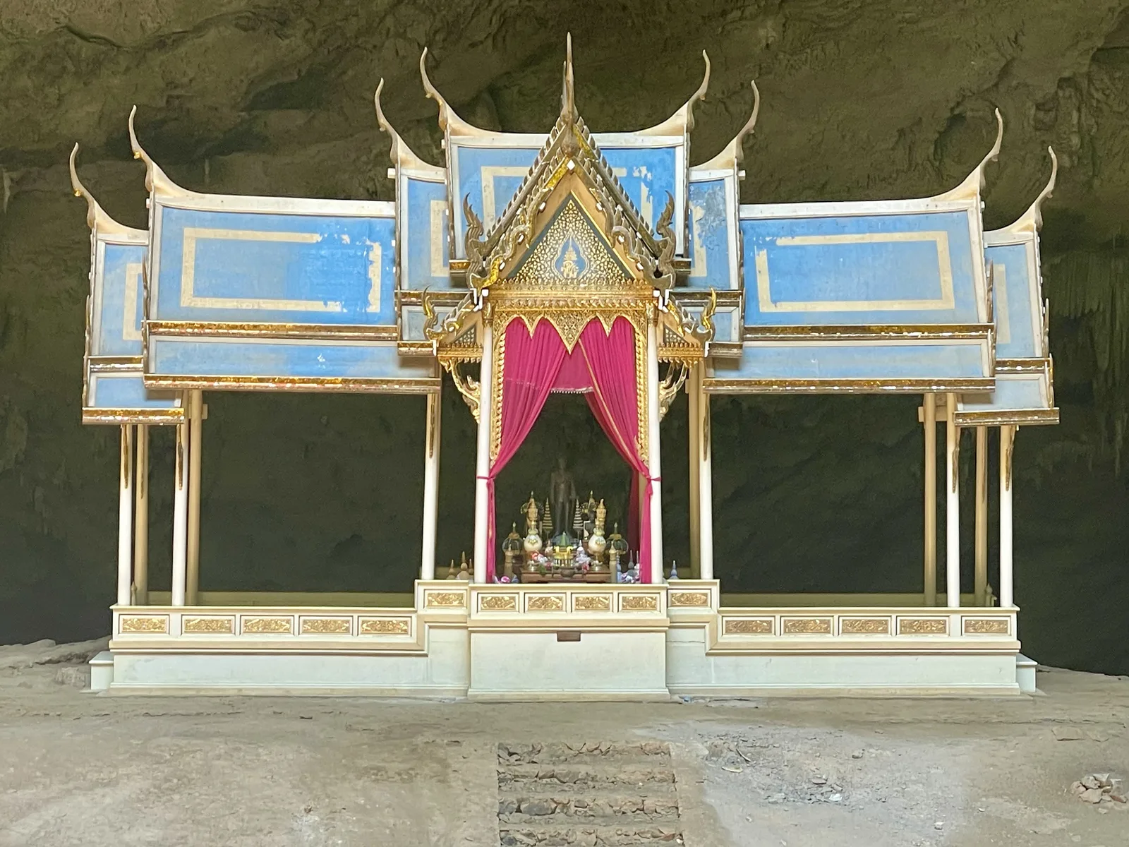 Front view of the blue and gold Kuha Karuhas royal pavilion standing alone inside Phraya Nakhon Cave